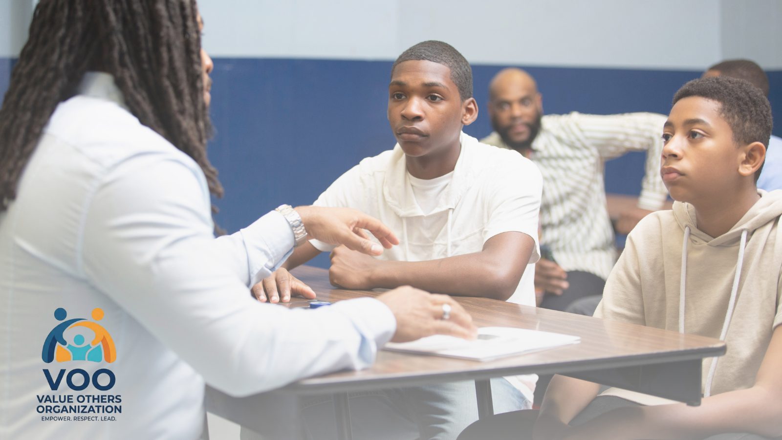 A mentor talking with youth during a VOO Value Talk
